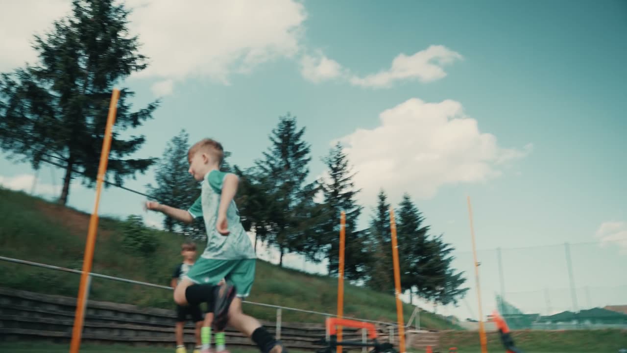 Mladá hráčka zrýchľuje medzi tréningovými tyčami počas cvičenia.